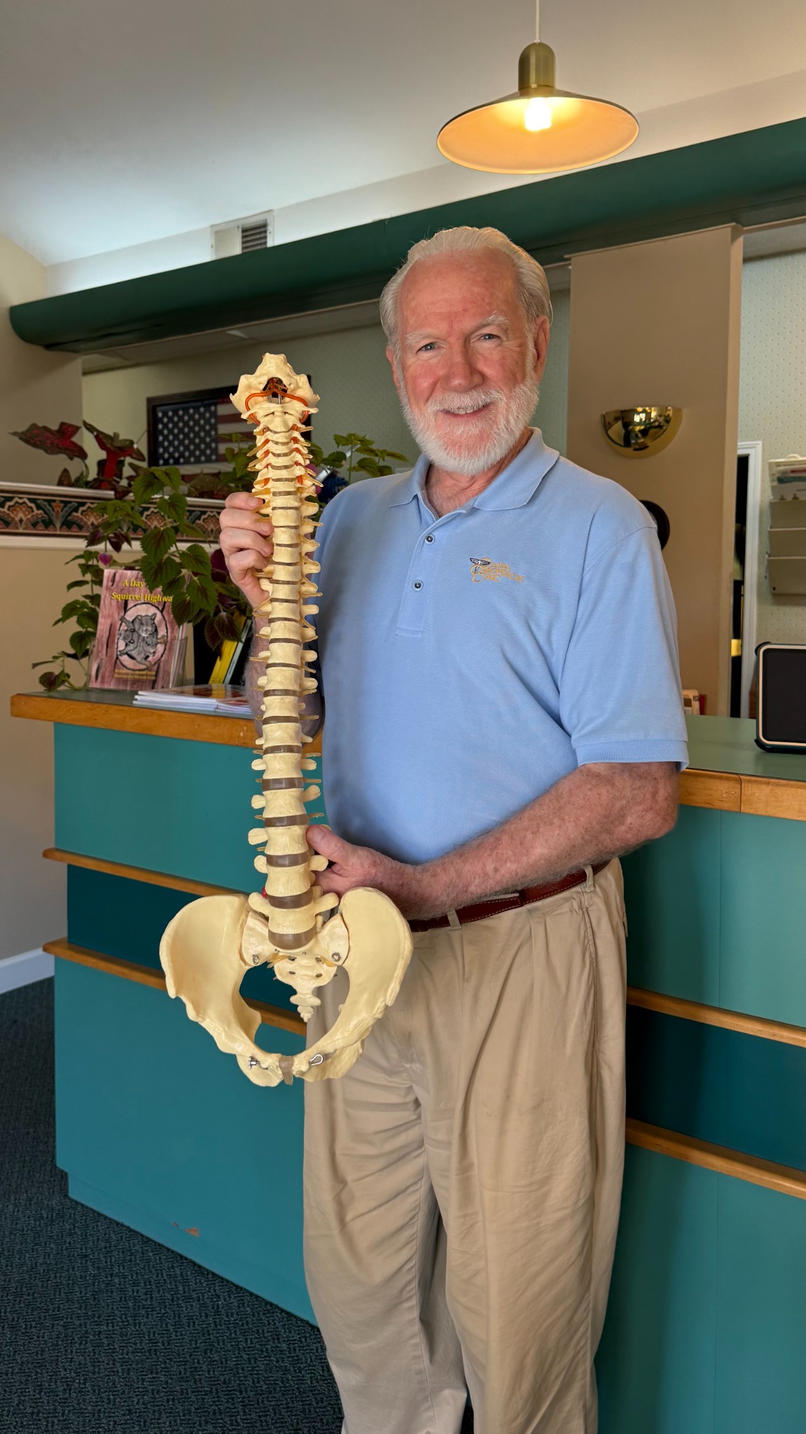 Dr. Jeffry Smith holding a spine model at Coastal Chiropractic Clinic
